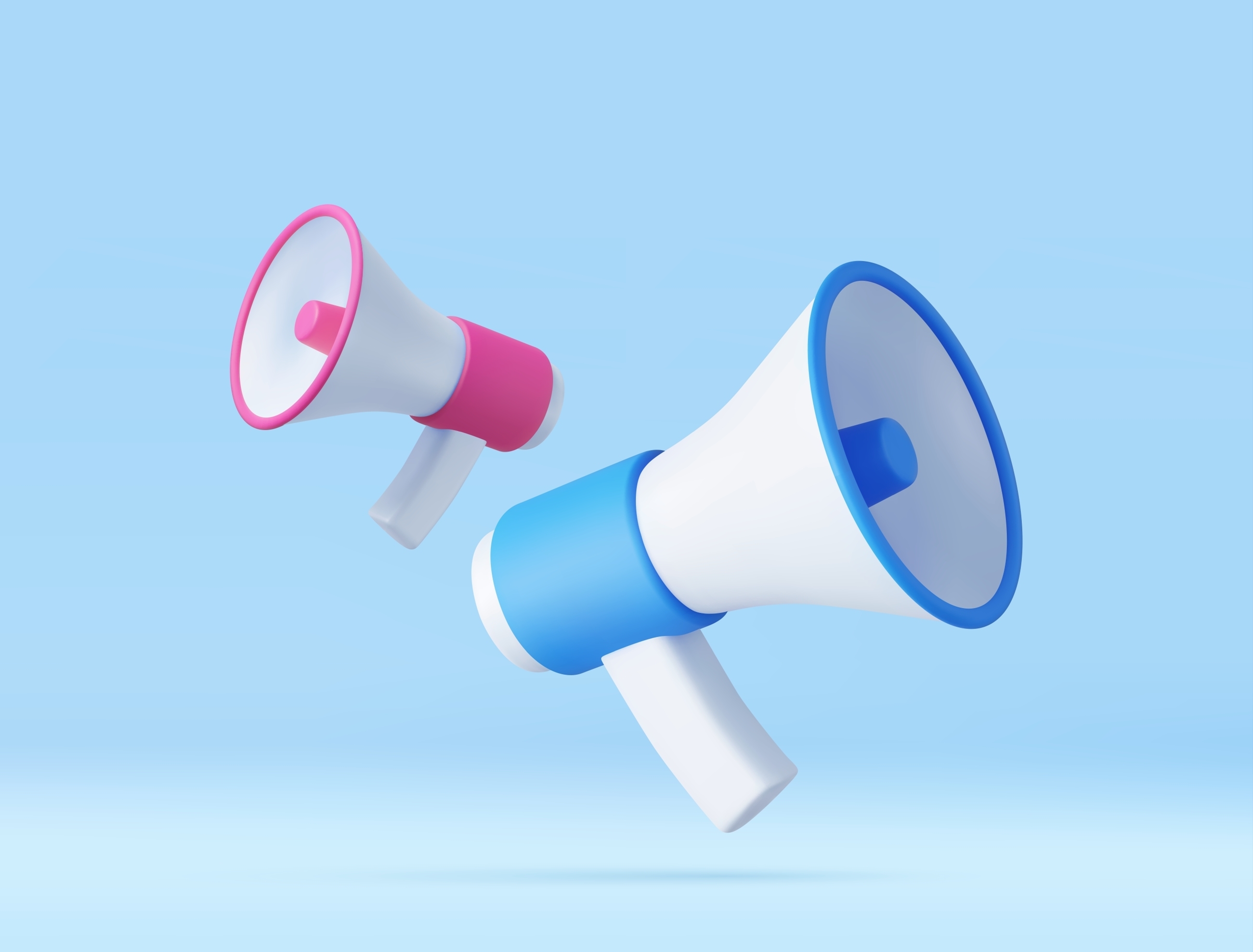 Pink and blue coloured megaphones on a blue background